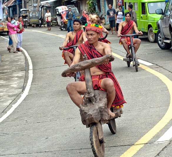 Igolot-Garonne-Tribe-Wears-Their-Costumes-and-Ride-a-One-of-a-Kind-Native-Wooden-Bike 0
